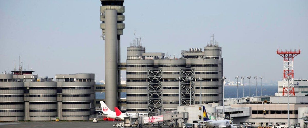 European airport with multiple aircraft at gates