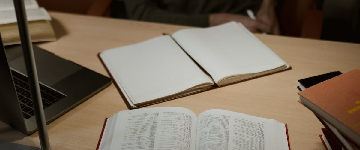 Pilot studying aviation textbooks and notes at a desk