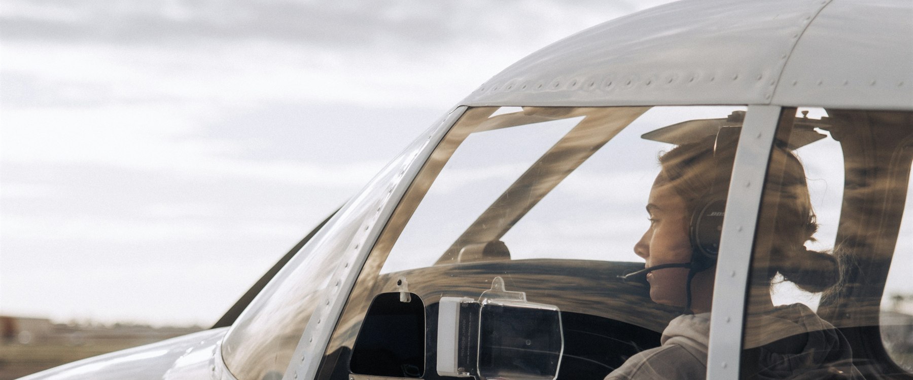 Pilot in cockpit of small aircraft