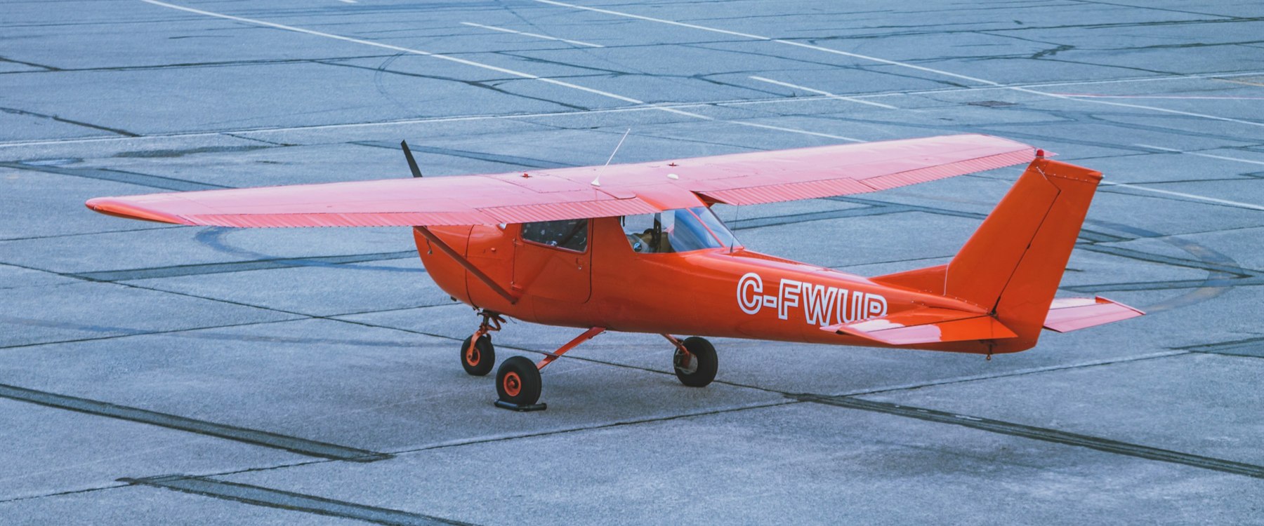 Small training aircraft on a flight school ramp